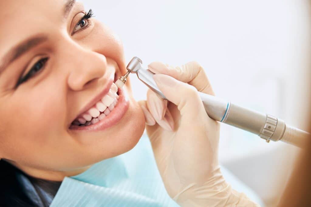 Close up of kind woman doing teeth cleaning